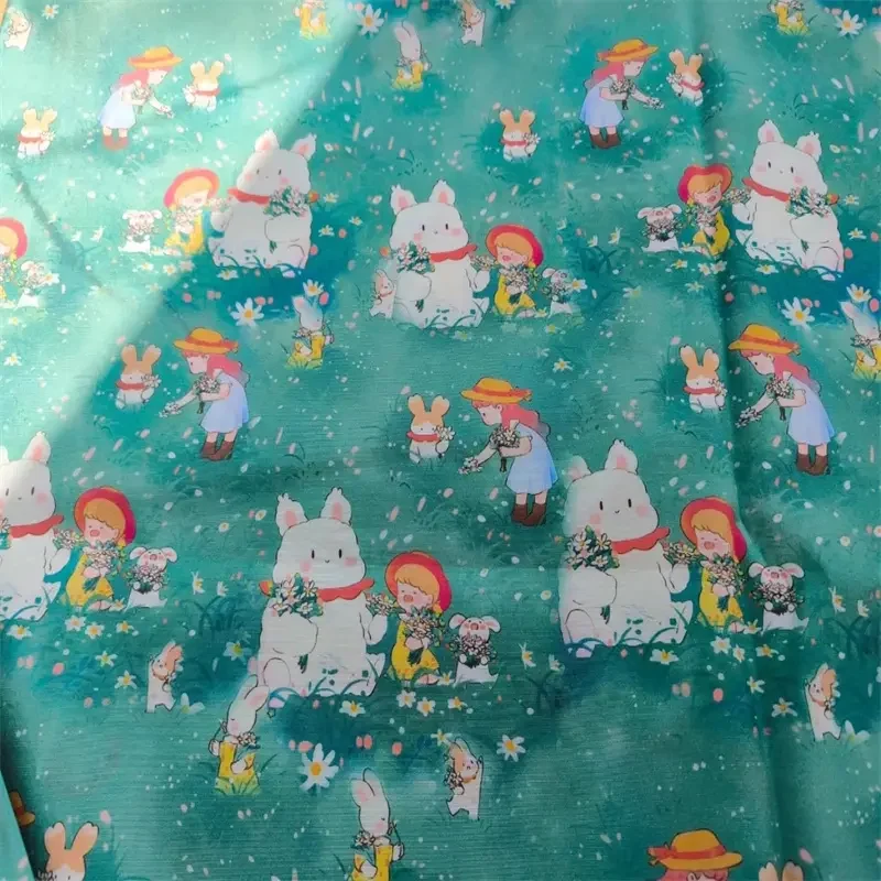 Little girl and cute bunny on lawn fabric